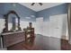 Bedroom with wood floors, double doors, and antique dresser at 506 W Mcintosh Rd, Brooks, GA 30205