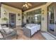 Relaxing covered patio with wicker furniture and fireplace at 506 W Mcintosh Rd, Brooks, GA 30205