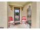 Inviting front porch with red metal chairs and a wind chime at 506 W Mcintosh Rd, Brooks, GA 30205