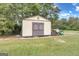 Large storage shed with double doors and wood siding at 506 W Mcintosh Rd, Brooks, GA 30205