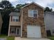 Two-story house with stone accents and a one-car garage at 7777 Newbury Dr, Jonesboro, GA 30236