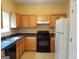 Galley kitchen with wood cabinets, granite countertops, and stainless steel appliances at 7777 Newbury Dr, Jonesboro, GA 30236