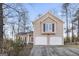 Beige two-story house with two-car garage and landscaping at 1934 Hobson Sw Ct, Marietta, GA 30064