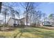 Tan house, front yard view, slight hill, tree-lined setting at 1934 Hobson Sw Ct, Marietta, GA 30064