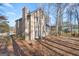 Tan house, backyard patio, wooded area, side view at 1934 Hobson Sw Ct, Marietta, GA 30064