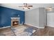 Living room with stone fireplace and blue accent wall at 1934 Hobson Sw Ct, Marietta, GA 30064