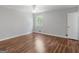 Bright bedroom featuring hardwood floors and a ceiling fan at 5893 Nell Ln, Ellenwood, GA 30294