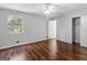 Bright bedroom with hardwood floors, a closet, and ceiling fan at 5893 Nell Ln, Ellenwood, GA 30294