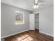 Bedroom with hardwood floors, window, and closet at 5893 Nell Ln, Ellenwood, GA 30294