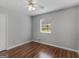 Bedroom with hardwood floors and window with blinds at 5893 Nell Ln, Ellenwood, GA 30294