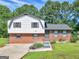 Brick and vinyl sided home with a landscaped yard and driveway at 5893 Nell Ln, Ellenwood, GA 30294