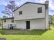 Back of house with vinyl siding, showcasing a private backyard at 5893 Nell Ln, Ellenwood, GA 30294