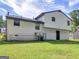 Rear view of a house with vinyl siding and a large yard at 5893 Nell Ln, Ellenwood, GA 30294