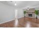 Living room features hardwood floors, a stone fireplace, and access to other rooms at 5893 Nell Ln, Ellenwood, GA 30294