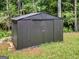 Black metal storage shed in backyard at 5893 Nell Ln, Ellenwood, GA 30294