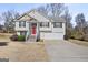 Two-story house with attached garage and red front door at 119 Bombay Ln, Grantville, GA 30220