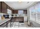 Galley kitchen with dark brown cabinets and tile backsplash at 119 Bombay Ln, Grantville, GA 30220