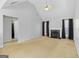 Living room with fireplace and vaulted ceiling, view of bathroom at 119 Bombay Ln, Grantville, GA 30220