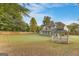 Large backyard featuring a two story home, gazebo and green lawn at 228 Otter Cir, Fayetteville, GA 30215