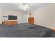 Spacious bedroom with large bed, dresser, and ceiling fan at 228 Otter Cir, Fayetteville, GA 30215