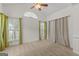 Bright bedroom with neutral carpeting and large windows with curtains at 228 Otter Cir, Fayetteville, GA 30215