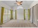 Bright bedroom with neutral carpeting and large windows with curtains at 228 Otter Cir, Fayetteville, GA 30215