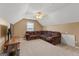Large bonus room with a comfortable sectional sofa and carpet flooring at 228 Otter Cir, Fayetteville, GA 30215