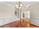Spacious dining room with hardwood floors, chandelier, and view to Gathering room at 228 Otter Cir, Fayetteville, GA 30215