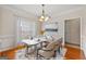 Elegant dining room with a stylish chandelier, wainscoting, and modern furniture, ideal for hosting gatherings at 228 Otter Cir, Fayetteville, GA 30215