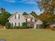 Charming two-story home featuring a combination of stone and vinyl siding, surrounded by mature trees and a well-maintained lawn at 228 Otter Cir, Fayetteville, GA 30215