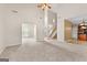 Open living room offering views of the staircase and kitchen at 228 Otter Cir, Fayetteville, GA 30215