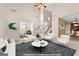 Bright, open-concept living room with high ceilings, modern furnishings, and seamless flow to other living spaces at 228 Otter Cir, Fayetteville, GA 30215