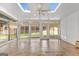 Bright sunroom featuring tile floors and multiple windows offering backyard views at 228 Otter Cir, Fayetteville, GA 30215