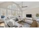 Bright living room featuring a sectional sofa and large windows at 525 Stonehaven Dr, Fayetteville, GA 30215