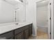 Bathroom boasts a vanity with dark cabinets and a shower/tub combo at 10231 Deep Creek Pl, Union City, GA 30291