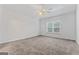 Bright bedroom with ceiling fan and neutral carpeting at 10231 Deep Creek Pl, Union City, GA 30291