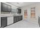 Modern kitchen with dark grey cabinets and marble-look floor at 10231 Deep Creek Pl, Union City, GA 30291