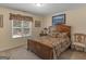 Bedroom with wooden bed frame, window, and additional seating at 925 Champions Way, Mcdonough, GA 30252