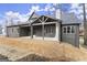 Backyard featuring a covered patio, a gray exterior, and a neatly maintained lawn at 220 Early Parkway Se Dr, Smyrna, GA 30082