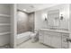 Neutrally-toned bathroom with white cabinets, a white countertop, and a tiled shower at 220 Early Parkway Se Dr, Smyrna, GA 30082