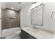 Modern bathroom featuring hexagon tile shower with a black vanity and a marble countertop at 220 Early Parkway Se Dr, Smyrna, GA 30082
