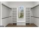 Large walk-in closet with custom shelving, storage, a bench, and a window providing natural light at 220 Early Parkway Se Dr, Smyrna, GA 30082