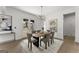 Dining area with a wooden table, gray upholstered chairs, modern lighting, and backyard access at 220 Early Parkway Se Dr, Smyrna, GA 30082