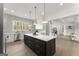 Bright kitchen featuring an oversized island with seating, quartz countertops, and modern lighting at 220 Early Parkway Se Dr, Smyrna, GA 30082