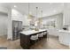 Spacious kitchen with a large island, white cabinets, stainless steel appliances and pendant lighting at 220 Early Parkway Se Dr, Smyrna, GA 30082