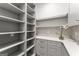 Walk-in pantry featuring ample shelving, quartz countertops, and modern gray cabinetry at 220 Early Parkway Se Dr, Smyrna, GA 30082