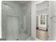 Elegant shower with glass enclosure, tiled walls, a shower niche, and a modern shower head at 220 Early Parkway Se Dr, Smyrna, GA 30082