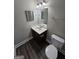This bathroom features wood-look floors, vanity with sink, and a toilet at 7214 Bedrock Cir, Lithonia, GA 30038