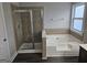 A relaxing bathroom features a glass shower and a soaking tub with tile accents at 7214 Bedrock Cir, Lithonia, GA 30038