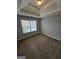 This cozy bedroom offers neutral walls, a window, and plush carpeting at 7214 Bedrock Cir, Lithonia, GA 30038